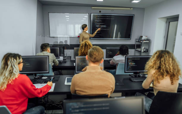 istock Female teacher and students in programming school 1462194451