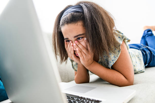 istock portrait of cute child using laptop on sofa 1462198478