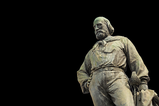 Bronze monument of the Italian general Giuseppe Garibaldi in the city of Pisa (Tuscany - Italy) - isolated on black background concept