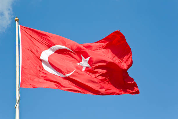 istock Turkish flag - Moon and star icon on red background against blue sky 1462199560