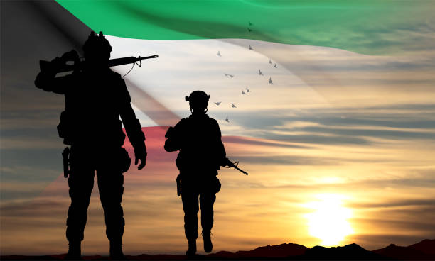 istock Kuwait flag and the silhouettes of a soldiers 1462199762