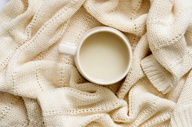 istock Cup of coffee with milk on white knitted blanket 1462199924