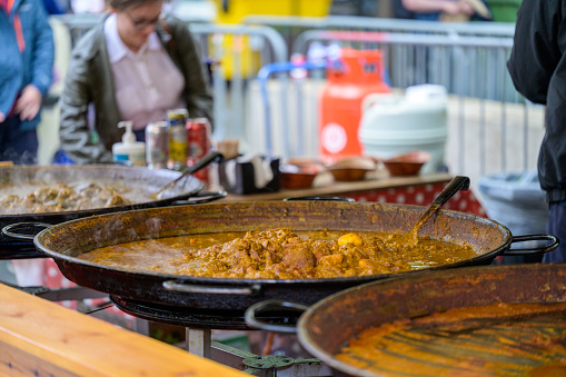 LONDON - May 20, 2022: Large pans of simmering curry at pop up street food stall on South Bank