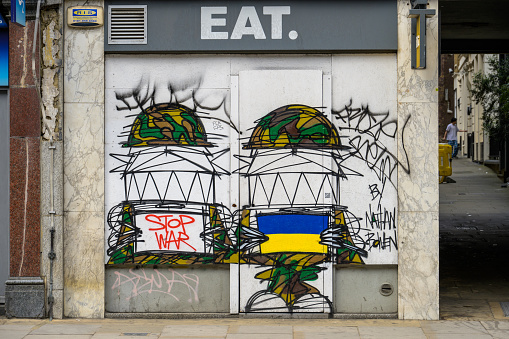 LONDON - May 21, 2022: Stop War Ukraine protest graffiti on side of unused building