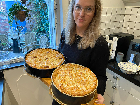Young woman showing a two fresh baked apple pies