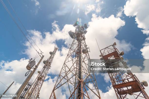 Cell And Radio Antennas Next To The Dirt Road In The Countryside Stock Photo - Download Image Now