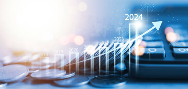 Coin drop 2024 new year business growth chart, positive indicator 2024, global company competitiveness, businessman calculating financial data for long term investment. stock photo