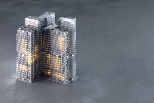 3D model of modern office building with illuminated windows on empty concrete background