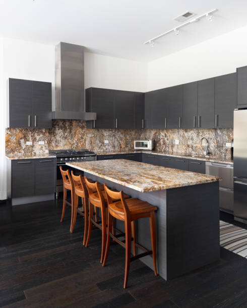 istock A modern kitchen with dark cabinets and granite countertops. 1462209892