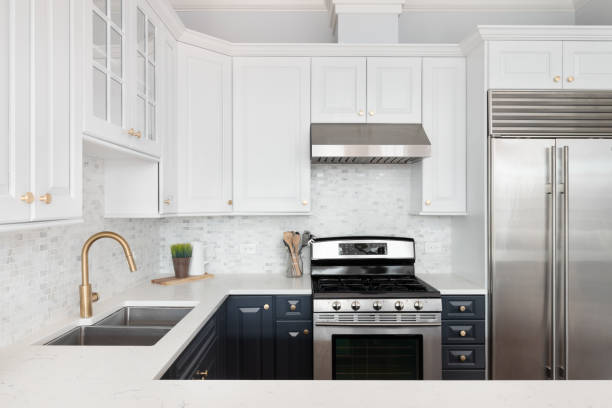 istock A modern kitchen with white and blue cabinets and a gold faucet. 1462209893