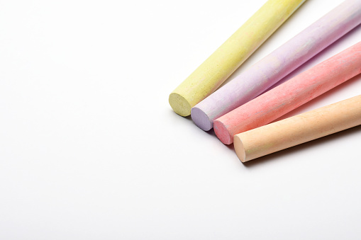 Colorful chalks on the white background