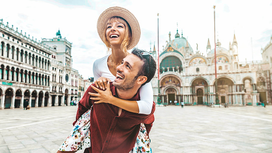 Romantic young couple enjoying vacation in Venice, Italy - Happy tourists visiting Italian city on summer holiday - Tourism and life style concept