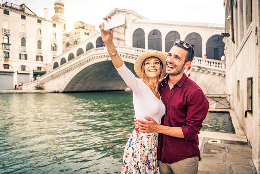 Romantic young couple enjoying vacation in Venice, Italy - Happy tourists visiting Italian city on summer holiday - Tourism and life style concept