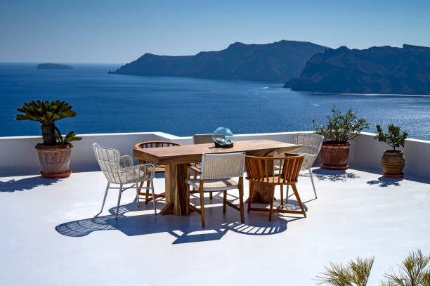 istock Romantic mediterraen vacation rooftop with table over the sea in Santorini 1462211578