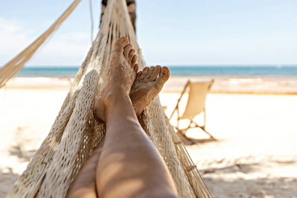 istock Woman's legs in the hammock against the ocean view 1462214634