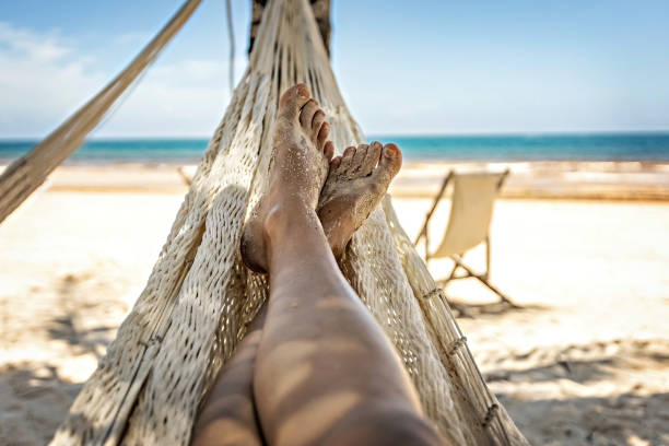 istock Woman's legs in the hammock against the ocean view 1462214648