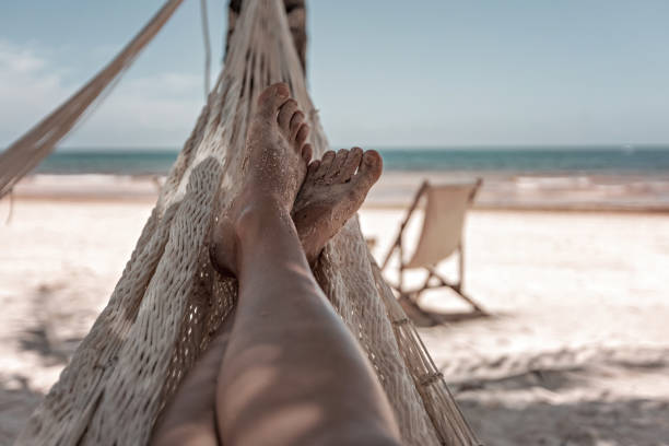 istock Woman's legs in the hammock against the ocean view 1462214681