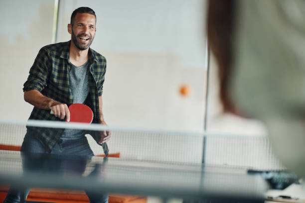 istock Happy man enjoying while playing table tennis. 1462214711