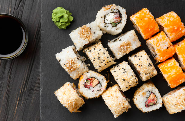 istock close up of sushi rolls on black tray 1462214767