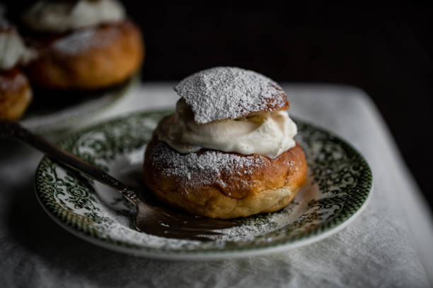 Semlor Homemade semla buns with frangipane and whipped cream on vintage plates finnish culture stock pictures, royalty-free photos & images