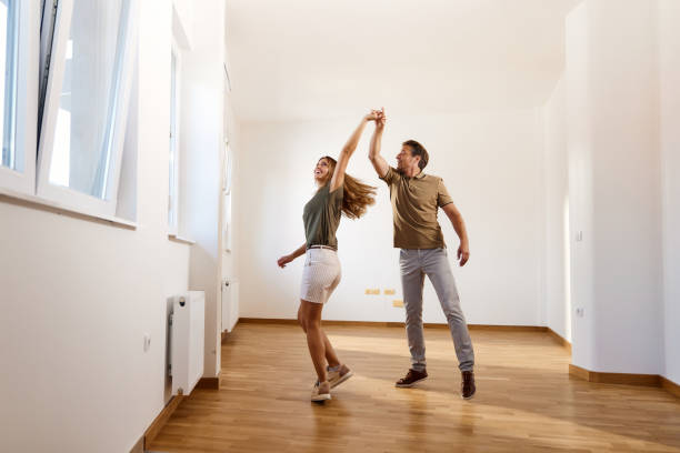 istock Happy couple dancing in their new apartment. 1462217061