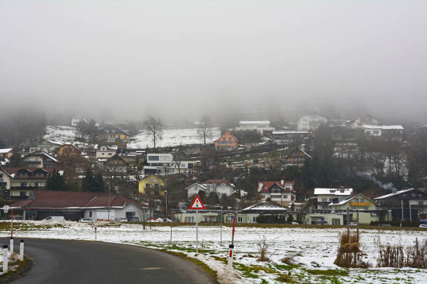 The foggy snowy winter landscape on the outskirts of Villach in Carinthia, Austria