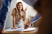 Frustrated woman talking to real estate agent in the apartment.