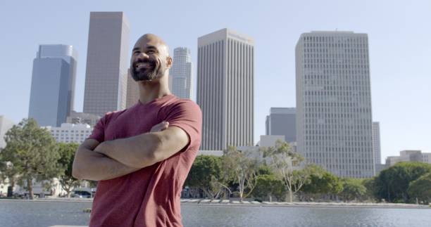istock Mixed race man looks around with folded arms in Downtown LA 1462218025