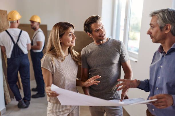 istock Couple talking about plans with an architect during home renovation process. 1462218168