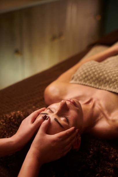 facial massage facial and head massage massage table stock pictures, royalty-free photos & images