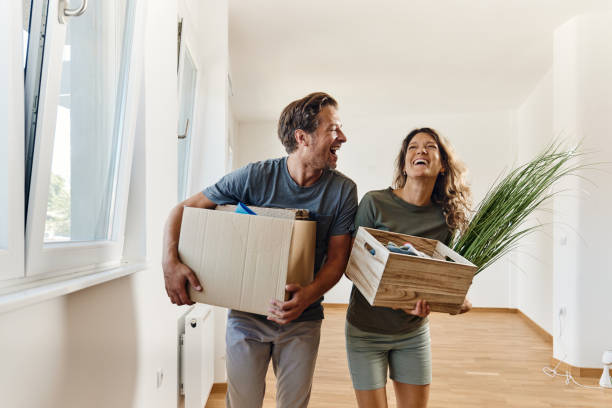 istock Cheerful couple talking while unpacking in their new apartment. 1462218307