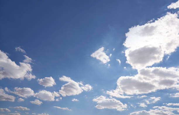 White cumulus clouds in a blue summer sky background