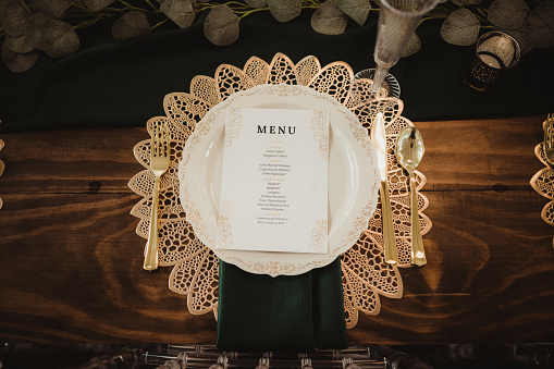 Boho place setting with menu on the table at a wedding