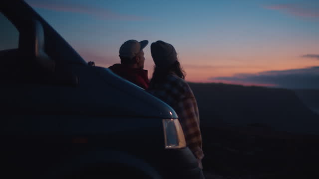 Soft vintage focus on dreamy couple look at sunset