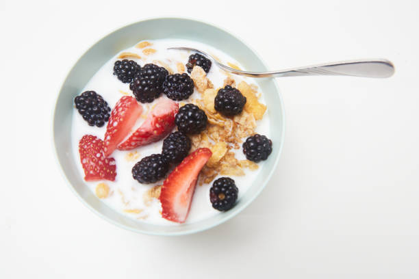 Bowl of cereal with fruit on a table