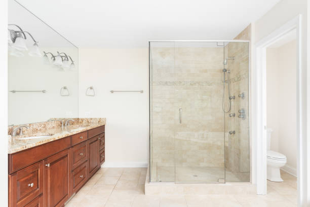istock A bathroom with a wood cabinet and tiled walk-in shower. 1462228143