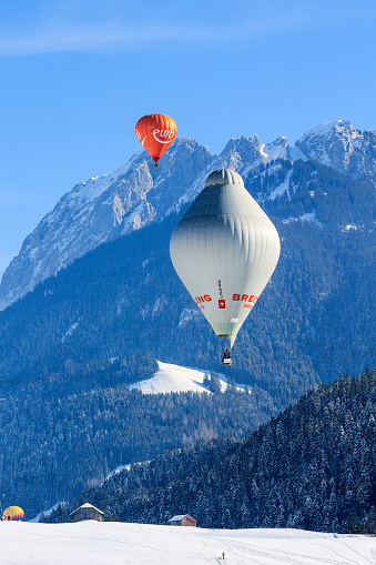 Chateau d'Oex, Switzerland - January 29. 2023: The balloon Breitling Orbiter 3 at the 43th International Hot Air Balloon Festival. It is named after Bertrand Piccard's balloon, the first for a non-stop flight around the globe in 1999.