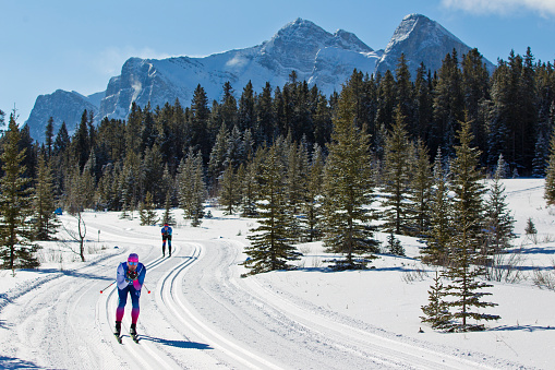 Two men in the tuck position on a long downhill during a cross-country ski race at the Canmore Nordic Centre Provincial Park in Alberta, Canada. (John Gibson Photo / Gibson Pictures)