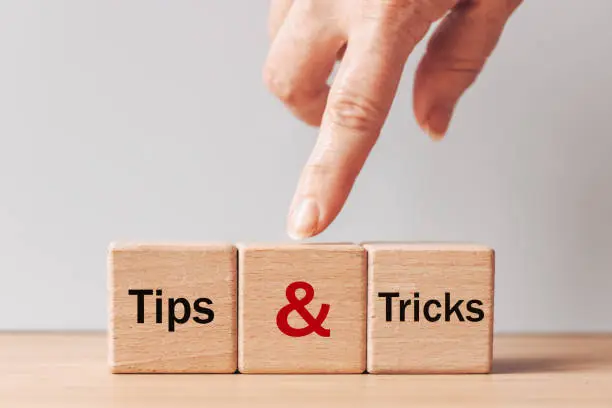 Photo of Tips and Tricks concept. written on wooden blocks, tips and tricks to help you in business