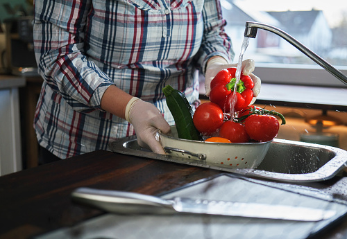 Food Safety - Washing Tomatoes, Bell Peppers, Zucchini in a Colander with Food Gloves