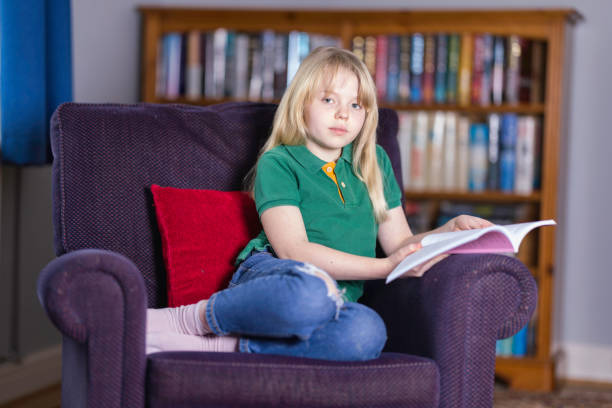 istock Ten year old relaxing with a book 1462249268