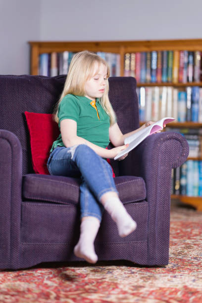istock Ten year old relaxing with a book 1462249300
