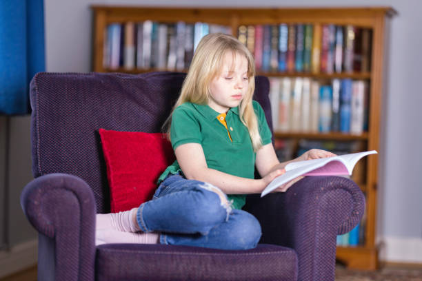 istock Ten year old relaxing with a book 1462249833