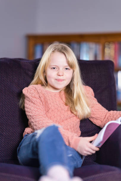 istock Ten year old relaxing with a book 1462251410