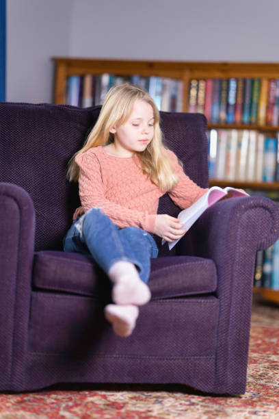 istock Ten year old relaxing with a book 1462253048