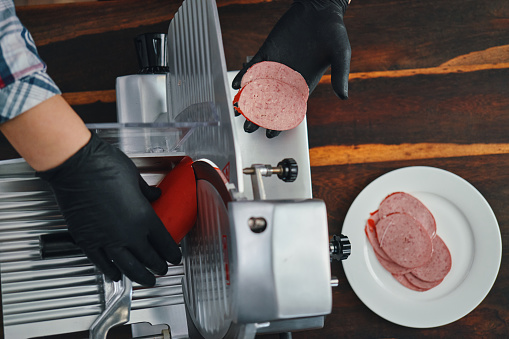 Food Safety - Slicing Baloney on Slicer Machine with Food Gloves
