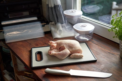 Food Safety - Cutting Chicken on Plastic Cutting Board with Food Gloves