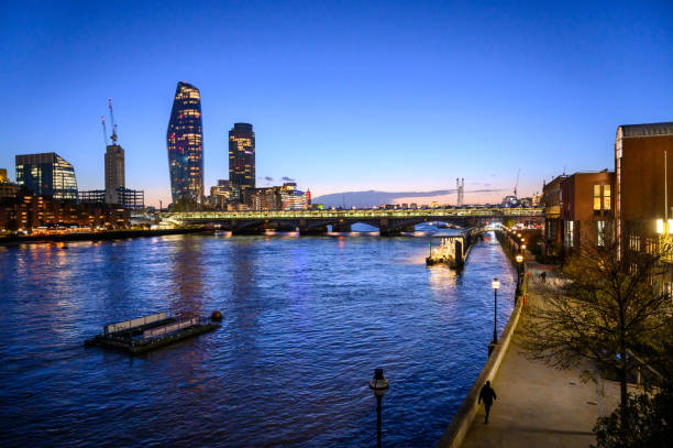 LONDON - November 2, 2020: View along the River Thames at golden hour. One Blackfriars, Southbank Tower and Blackfriars Railway Bridge.