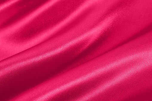 Pink satin wavy background.