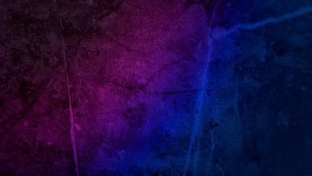Photo of marble stone wall with neon light, blue and purple gradient, on dark background. abstract cement wall use as background with space for design.